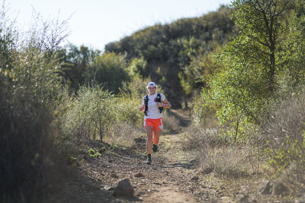 Woman running on a trail in the mountains